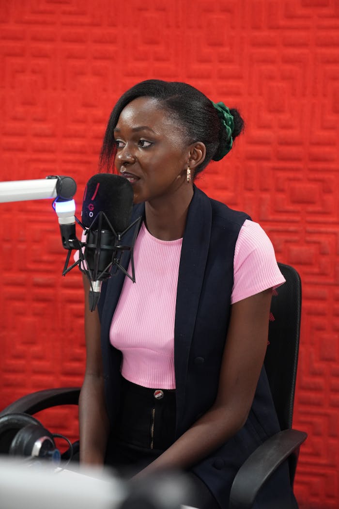 Woman engaging in a radio interview in a Kampala studio